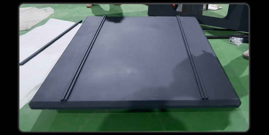 Top cover panel with two T-slot rails laid on factory floor
