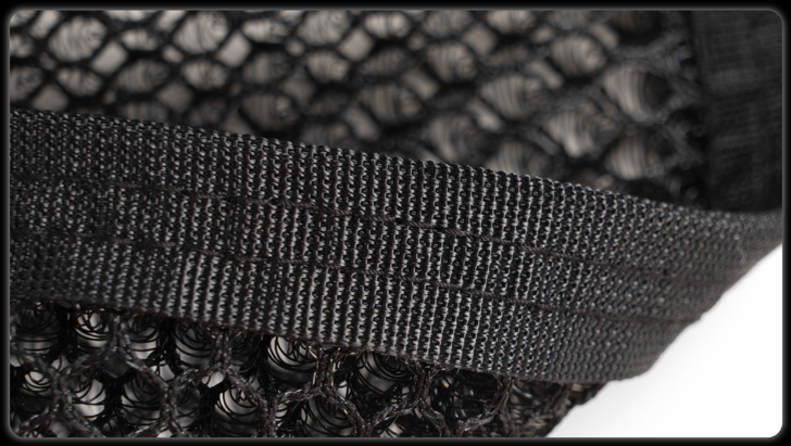 Close-up of woven edge binding and layered mesh construction