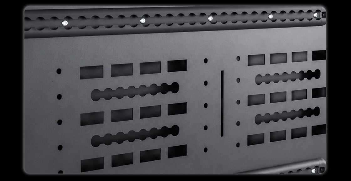 Close-up of MOLLE panel hole pattern with T-bolts rectangular cutouts and wavy slots