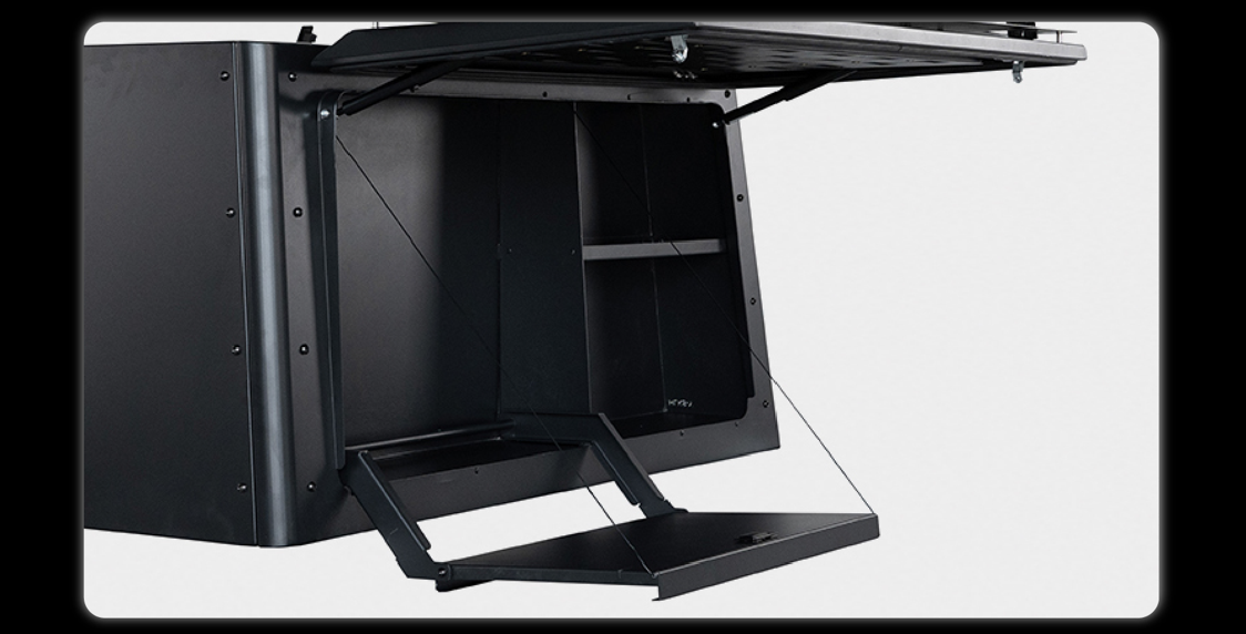 Slide-out kitchen interior showing storage compartments shelf and fold-down table mechanism