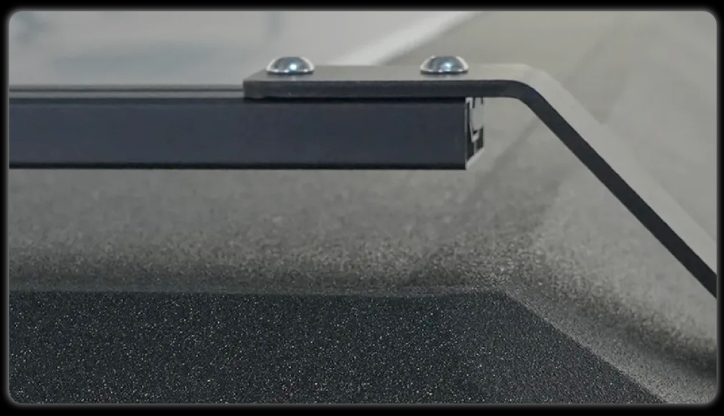 Roof rack bracket close-up showing powder-coated steel construction with stainless steel mounting bolts