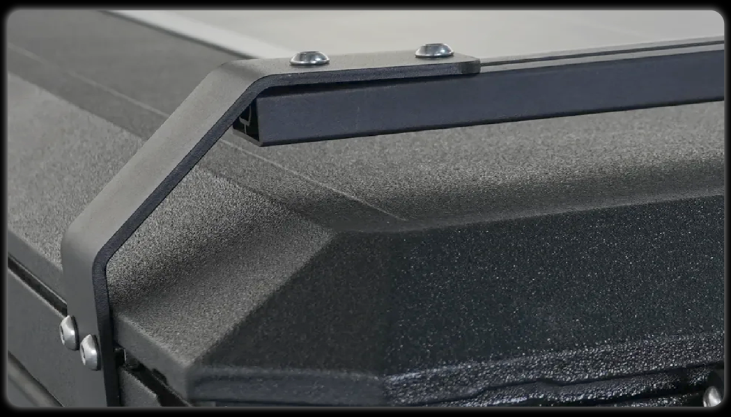 Roof rack L-bracket detail showing dual bolt mounting and sturdy rail connection