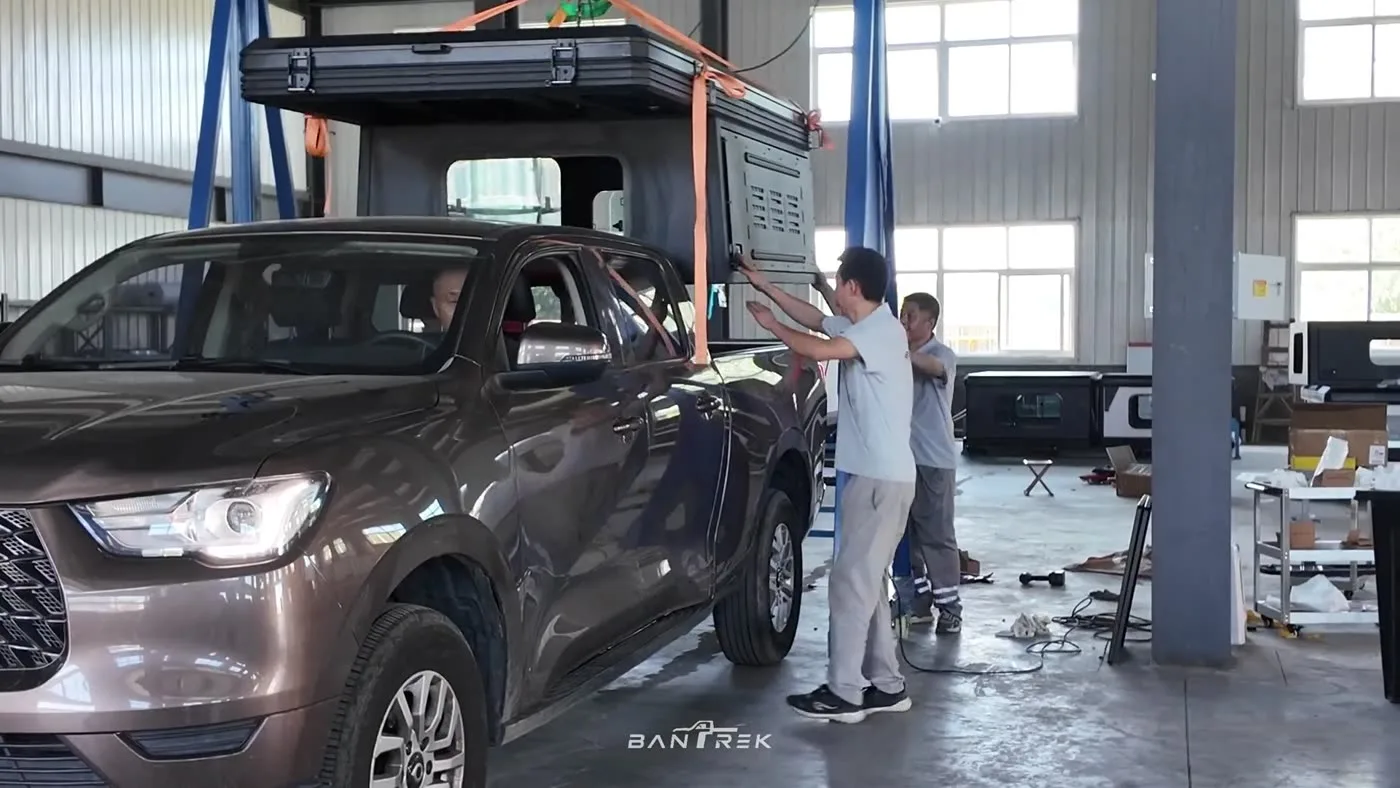 The finished Bantrek camper being securely lowered onto a pickup truck bed